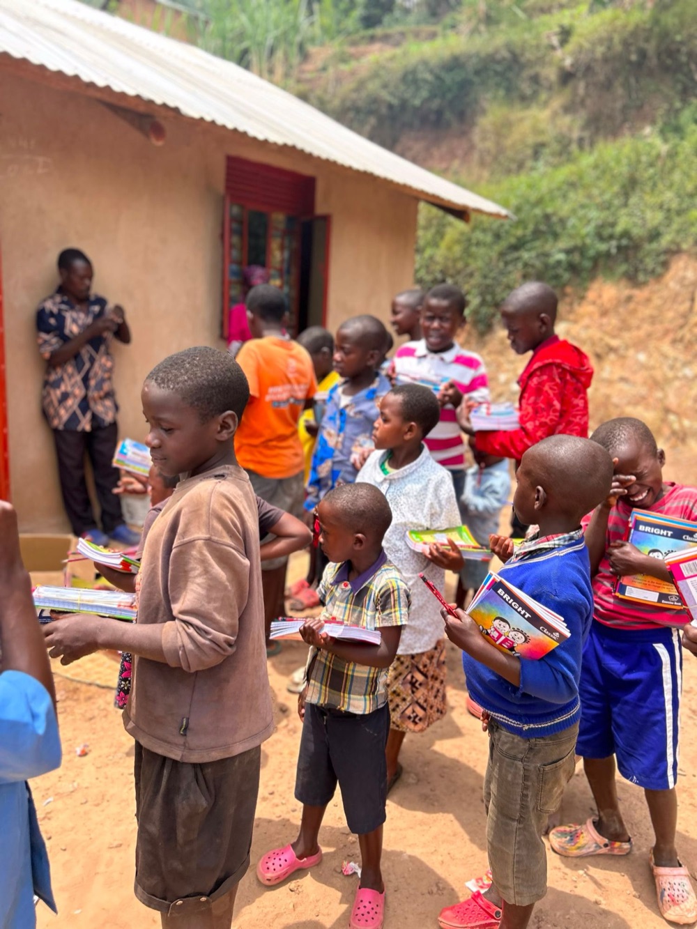 Children lining up outside a house to collect their exercise books